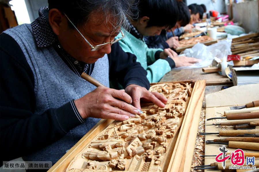 安徽省黄山市民间工匠正以锋利的手工工具刻凿装饰木质物上精美图案。 安徽省黄山市民间工匠正以锋利的手工工具刻凿装饰木质物上精美图案。
